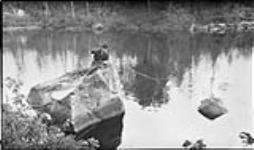 Edna [Boyd] fishing from a rock at Long Lake, Bala, [Ont.] August, 1918 Aug. 1918