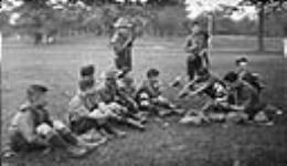 Chinese Boy Scouts eating lemons in High Park, Toronto, Ontario. June 8, 1919 June 8, 1919