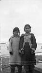 Native girls on North-East coast of Baffin Island. [Martha Qaurinniq Akumalik (left) and Ukpigjuujaq (right), who is wearing a traditional "amauti".] 17 Sept. 1924