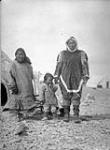 [Inuit man, woman, and child] Original title: Native group 13 August 1930.