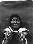 Arnakallak, Pond Inlet, Baffin Island, N.W.T., August 1931. [Maata Qumangaapik wearing a women's caribou parka used for photographs. She was the adoptive mother of Cornelius Nutarak, a local Elder of Pond Inlet.] August 1931.