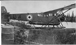 Method of portaging light rigid 17 foot canoe by aeroplane 1931