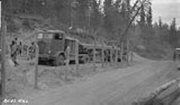 American Army trucks unloading pipe. Canol project., Water- front - Lot 51 (Ryans) 1942