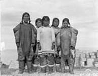 A group of native women. [Left to right: Paula, Maniq, Niiquq Inuujaq, Arnaujaq and Ikkarrialuk. They had unloaded a "sealift".] c.a. 1924