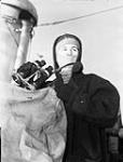 Able Seaman H.W. Gillis, who is wearing a woolen balaclava supplied by The Canadian Red Cross Society, Halifax, Nova Scotia, Canada, 5 February 1943 February 5, 1943.