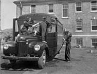 Personnel of the Women's Royal Canadian Naval Service (W.R.C.N.S.) washing a bus at H.M.C.S. CONESTOGA, Galt, Ontario, Canada, July 1943 July, 1943.
