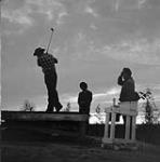 [Golfing at midnight on the golf course at Yelloknife, N.W.T., July 1960.]