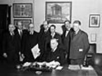 Rt. Hon. W.L. Mackenzie King witnessing the signing of a loan agreement with the United Kingdom 6 Mar. 1946