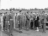 H.R.H. Princess Juliana presenting awards to members of the tug-of-war team of The South Saskatchewan Regiment, Nijmegen, Netherlands, 11 August 1945 August 11, 1945.