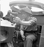 Lance-Bombardier W.J. Pelrine in a Priest M-7 self-propelled gun of the 14th Field Regiment, Royal Canadian Artillery (R.C.A.), France, 20 June 1944 June 20, 1944.