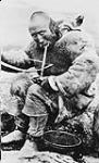 [Copper Mine eskimo bow drilling, Copper Mine, N.W.T.] [c.a. 1915]