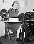 Private Marjorie Cox of the Canadian Army Film and Photo Unit splicing film, Merton Park Studios, London, England, 19 December 1944 Deember 19, 1944.