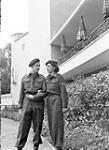 Corporal Wally Crouter and Sergeant Kay Crouter of the Canadian Army Show outside the Ravenna Club, Utrecht, Netherlands, 25 August 1945 August 25, 1945.