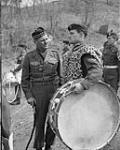 Brig. J.M. Rockingham chats with bass drummer D.V. Thurn, 1st Battalion Princess Patricia's Canadian Light Infantry Band, on his farewell tour of Korea 21 Apr. 1952