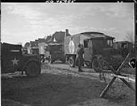 Ambulances checking out and given their destinations at guard post 4 Feb.1945