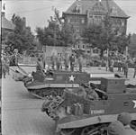 4th Princess Louise Dragoon Guards'(PLDG) carriers pass saluting stand 10 June 1945