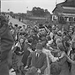 Dutch civilians mobbing Canadian soldiers and demanding their autographs, at the time of the Liberation 9 May 1945