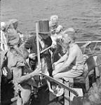 H.M.C.S. UGANDA Commander Pullen being prepared for 'initiation ceremony' aboard ship 7 Mar. 1945