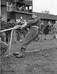 Lieutenant-Colonel M.W. Andrew of The Perth Regiment, anchorman of the officers' tug-of-war team, Track and Field Day, Sneek, Netherlands, 3 July 1945 July 3, 1945.