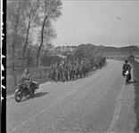German Prisoners of War escorted by Canadian Provost Corps motorcyclists of the 1st Canadian Division. Twello (vic.), Netherlands, 13 April 1945 13 Apr. 1945