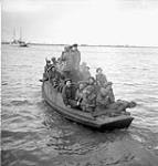 Personnel of The Toronto Scottish Regiment (M.G.) aboard a motorboat en route from Beveland to North Beveland, Netherlands, 1 November 1944 November 1, 1944.