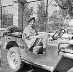 Nursing Sister Constance Browne of the Royal Canadian Army Medical Corps (R.C.A.M.C.) sitting in a jeep, Leonforte, Italy, 7 August 1943 August 7, 1943.