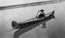 Robert Service in canoe somewhere between Fort Smith and Fort Norman 1911