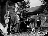 Aigeldinger-Ortolf German Settlement (Fort William vic.). L. to r.: S.H. Wilson (Gov. Colonization Agent), Mr. Yager (North German Lloyd Steamship Co.), Mrs. E. Berger and son, Mrs. Ortolf and daughter and Mr. Aigeldinger in front of Aigeldinger's house May 28, 1926