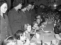 Personnel of 42 Company, Canadian Women's Army Corps (C.W.A.C.), hosting a Christmas party for children, England, 19 December 1943 Deember 19, 1943.