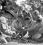 Children examining a three-inch mortar with infantrymen Gérard Gauthier, Charles-Eugène Lafond and Omer Manceau of Les Voltigeurs de Québec, England, 20 August 1943 August  20, 1943.