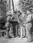 Polish servicewomen searching German workers at main gate of German prisoner-of-war camp for female personnel of the Polish Army 7 May 1945