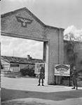 Canadians in Germany. Two Canadian guards at main outer gates of internment camp for Nazi officials 8 June 1945