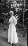 Unidentified woman leaning against tree ca. 1908