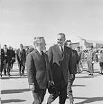 Columbia River Ratification. Prime Minister Lester B. Pearson with President Lyndon B. Johnson on airport tarmac possibly after air tour of the Columbia River complex 14 - 16 Sept. 1964.