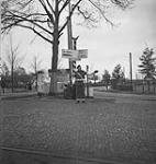 Lance-Corporal Charlie Duggan, Canadian Provost Corps, directing traffic 1 Apr. 1945
