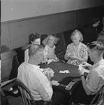 Group of people playing their regular Wednesday night game of whist in Taylorton, centered in the Estevan-Bienfait coal fields of Saskatchewan June 1946