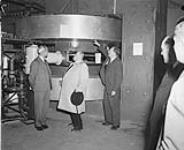 Mayor Camilien Houde examining the cyclotron at McGill University 24 Nov 1948
