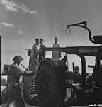 Military personnel cleaning barrel of anti-aircraft gun at R.C.A.F. Station May 1943