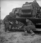 Sargeant Chuck Pickard and Troopers Ernie Tester and Norman Testerin front of armoured vehicle 19-Jul-44