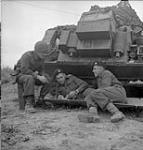 Sargeant Chuck Pickard and Troopers Ernie Tester and Norman Tester in front of armoured vehicle 19-Jul-44