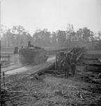 Personnel carrier of the Stormont Dundas and Glengarry Highlanders crosses Bailey bridge over the Orne River built by Royal Canadian Engineers 18-Jul-44