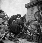 French children placing flowers on memorial during a Mass celebrating Bastille Day 13-Jul-44