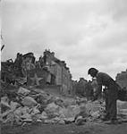 Canadians soldiers cleaning the road of rubble 10 July. 1944