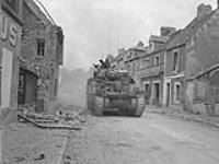 Sherman tanks of the Sherbrooke Fusiliers advancing into Caen 10 July. 1944