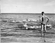 Instructor Peter Trim of Prince Albert National Park instructs class in swimming c.a. 1945