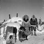Inuit family outside igloo [Left to Right: possibly Naikak, Noanikhok and Nokadlak] 1950