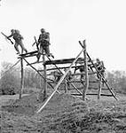 Infantrymen of the Cape Breton Highlanders running through the obstacles of an assault course, Sheffield Park, England, 8 December 1942 Deember 8, 1942