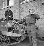 Corporal W.E. Oliver, Royal Regiment of Canada, directing mortar fire, watched by Private J. Keller, driver of their Universal Carrier, France, 28 September 1944 September 28, 1944