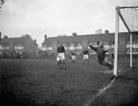 Norway's goalkeeper A. Borgen stopping a Canadian shot during a Canada - Norway charity soccer match to benefit St. Dunstan's School, Harrow, England, 28 October 1944 October 28, 1944.