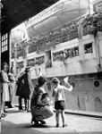 Relatives awaiting the arrival of Canadian soldiers from overseas aboard the troopship S.S. ILE DE FRANCE , Halifax, Nova Scotia, Canada, June 1945 June 1945